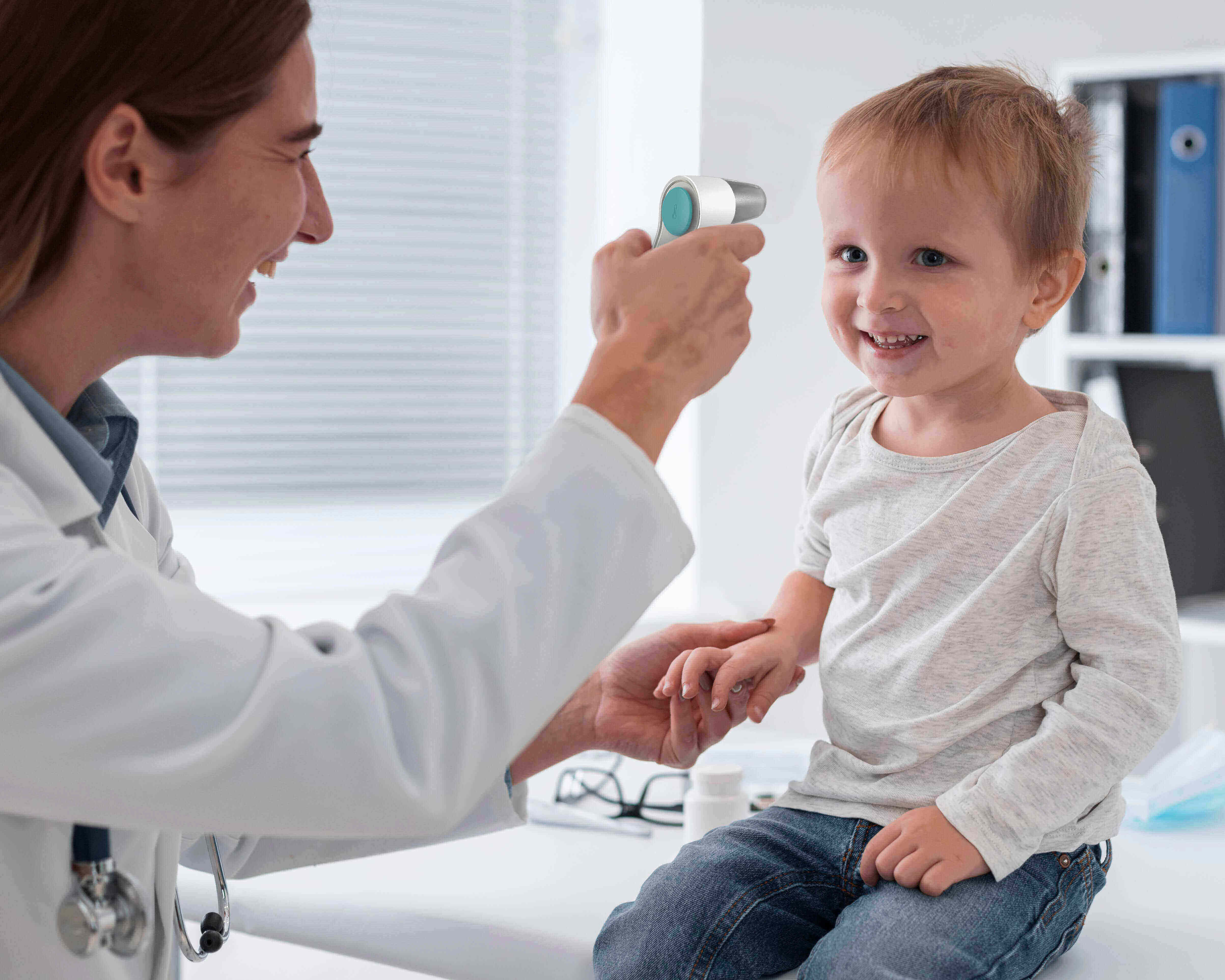 Measuring a boy's body temperature